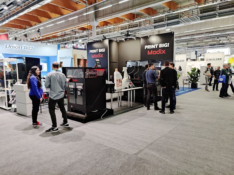 Modix trade show booth with printers and visitors